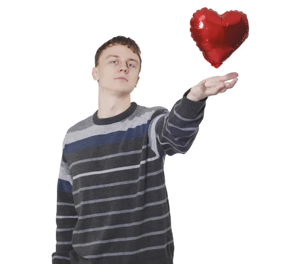 stock image Young handsome man with red heart balloon