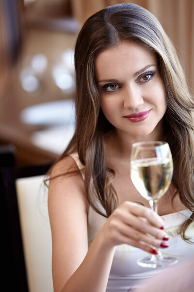 Attractive girl with a glass in a restaurant