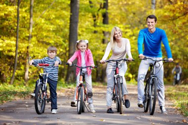 Families with children on bicycles clipart
