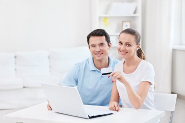 A couple with a credit card clipart