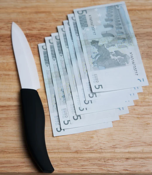 stock image Knife and money on a chopping board