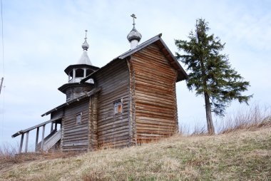 Orthodox wooden church in the village of Manga, Karelia, Russia clipart