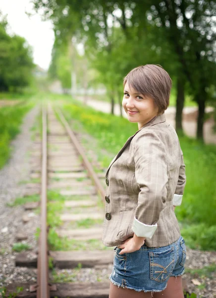 Girl standing on the railroad — Stock Photo, Image