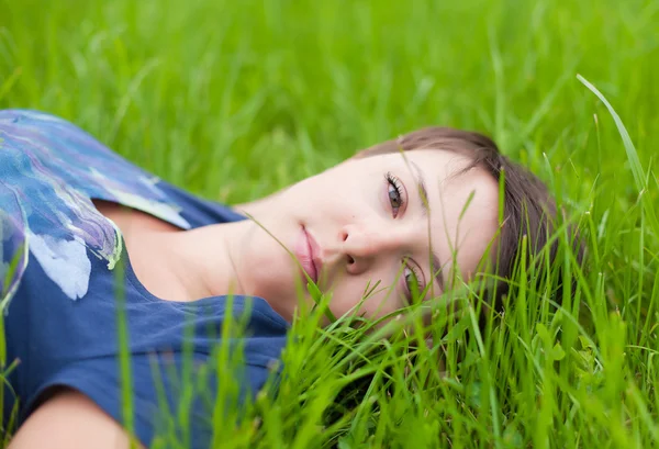 stock image Young Woman relaxing on the green grass