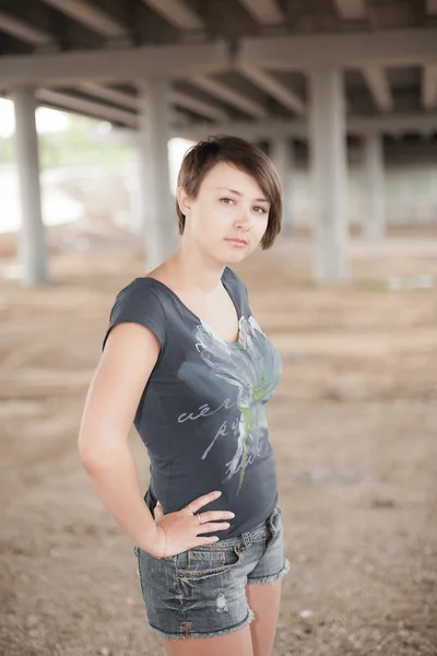 Brunette posing in the industrial site — Stock Photo, Image