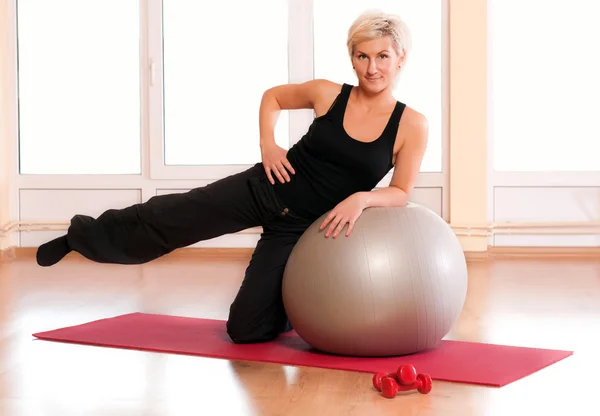 Młoda kobieta w sprawny, robienie ćwiczeń fitness z fit ball. — Zdjęcie stockowe