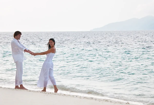 Foto van romantische jong koppel met een voet op de zee sho — Stockfoto
