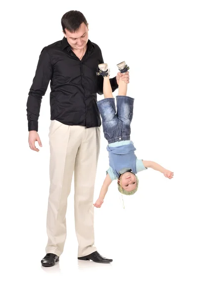 Stock image Man holds little boy upside down