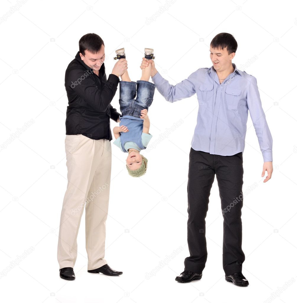 Two gusd holding little boy upside down