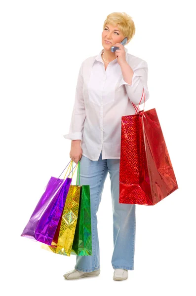 Senior woman with bags and mobile phone — Stock Photo, Image