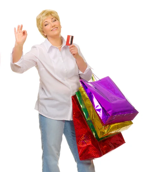 Senior woman with bags and credit card — Stock Photo, Image