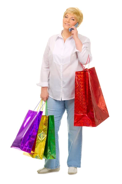 Senior woman with bags and mobile phone — Stock Photo, Image