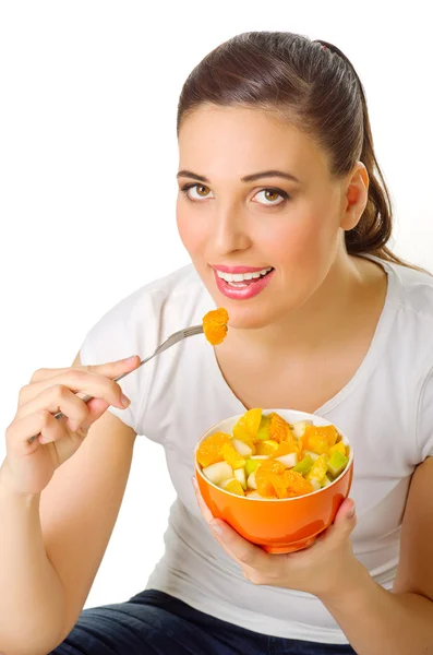 Молодая девушка ест фрукты Стоковое Фото