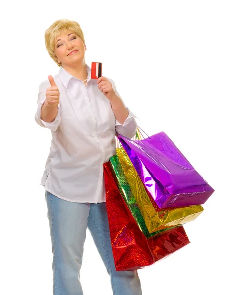Happy senior woman with bags and credit card — Stock Photo, Image