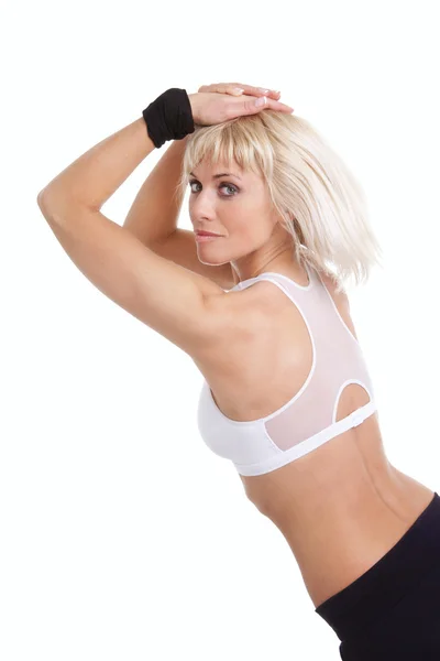 Ξανθιά γυναίκα κατάρτισης γυμναστήριο πάνω από λευκό — Φωτογραφία Αρχείου