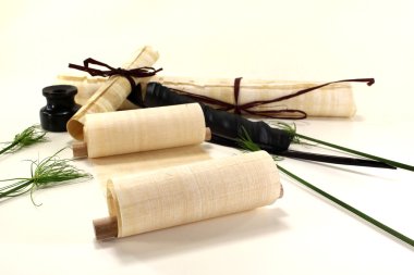 Papyrus rolls with inkwell and pen clipart