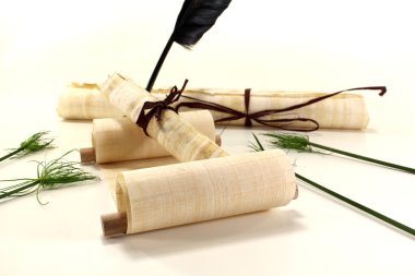 Papyrus rolls with inkpot and quill clipart