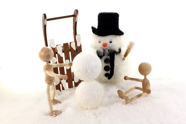 Children build a snowman — Stok fotoğraf