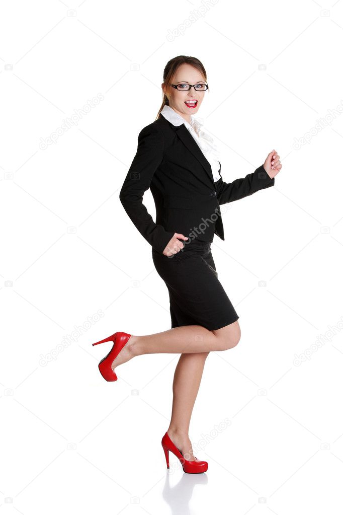 Young happy businesswoman in a rush