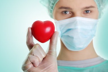 Doctor holding heart shape toy clipart