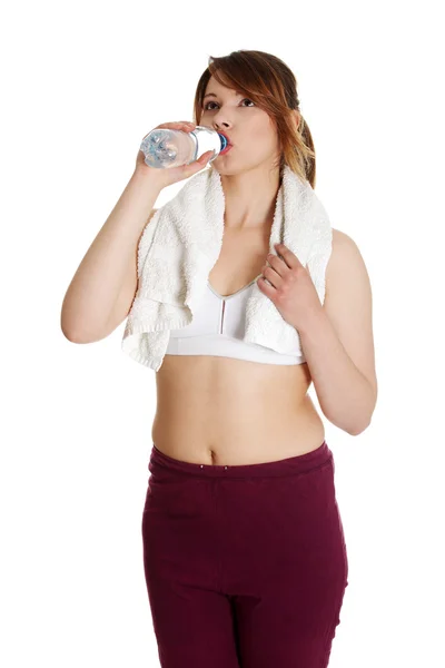 Durstige junge Frauen trinken Wasser nach der Fitness — Stockfoto