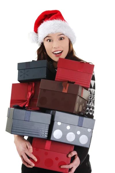 Woman in santa hat holding christmas boxes, — Stock Photo, Image