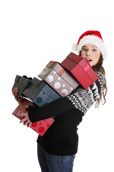 Woman in santa hat holding christmas boxes, — Stock Photo, Image