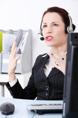 Mad businesswoman talking by headset. clipart