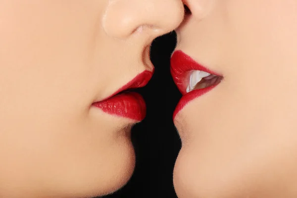 stock image Closeup of pair women mouths kissing