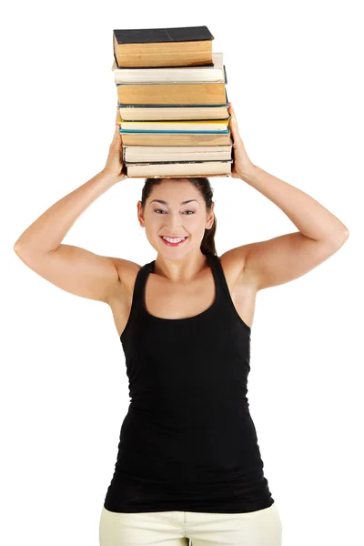 Młoda kobieta (uczeń) z książki na głowie — Zdjęcie stockowe