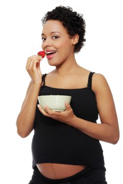 Pregnant woman eating healthy food. clipart