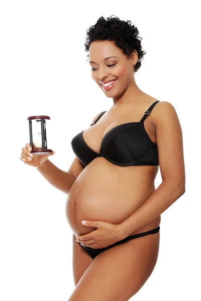 妊娠中の女性は黒のランジェリーで服を着てください。. — ストック写真