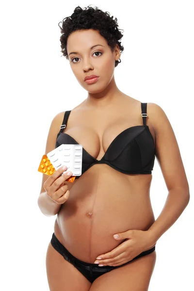 Gravid kvinna klädd i svart underkläder. — Stockfoto