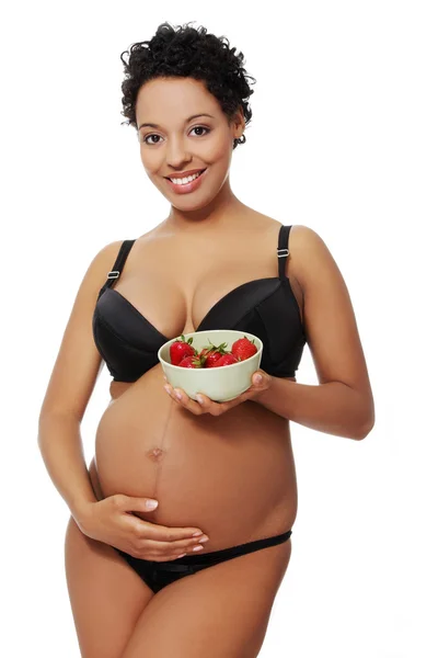 Glad gravid kvinna klädd i svart underkläder. — Stockfoto