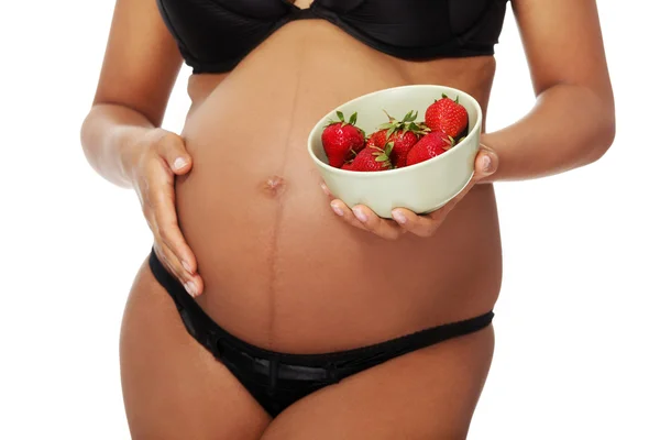 Pregnant woman dressed in black lingerie. — Stock Photo, Image
