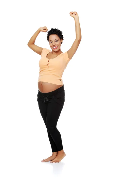 Pregnant woman stretching her body. — Stock Photo, Image