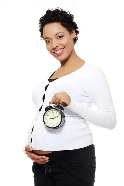 Gravid kvinna med en väckarklocka. — Stockfoto