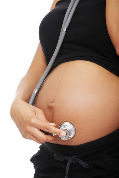Těhotná žena se stetoskopem. — Stock fotografie