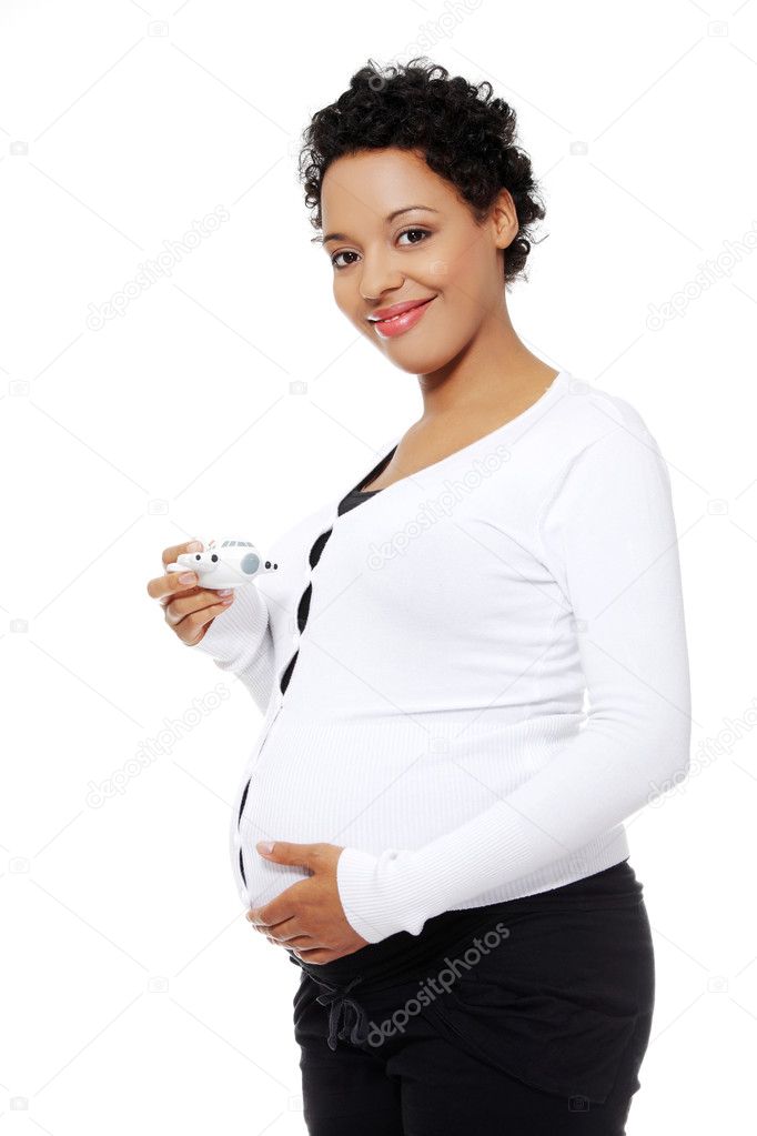 Pregnant woman with a toy airplane.