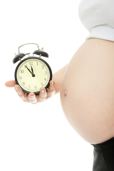 Hamile kadın holding çalar saat — Stok fotoğraf