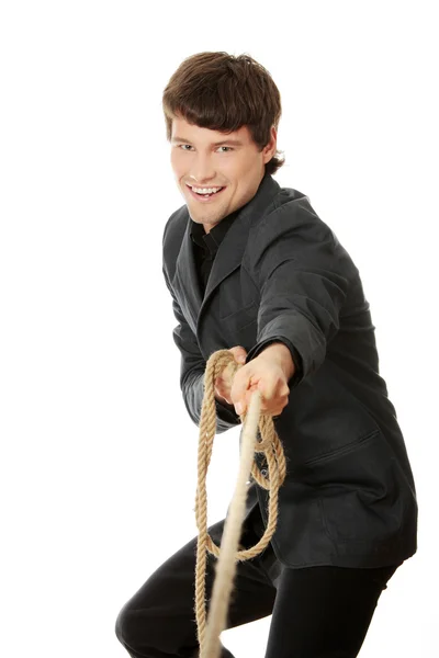 Businessman pulling on a rope. — Stock Photo, Image
