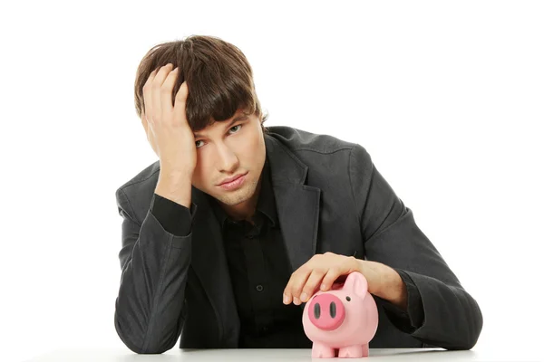 Jonge depressief zakenman houden piggy bank — Stockfoto