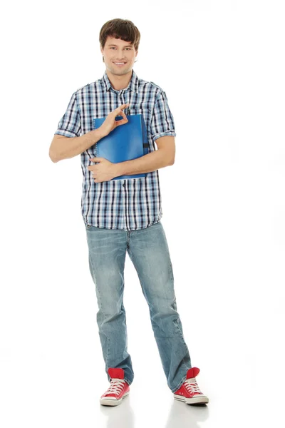 ノートブックを持つ若い学生男 — ストック写真