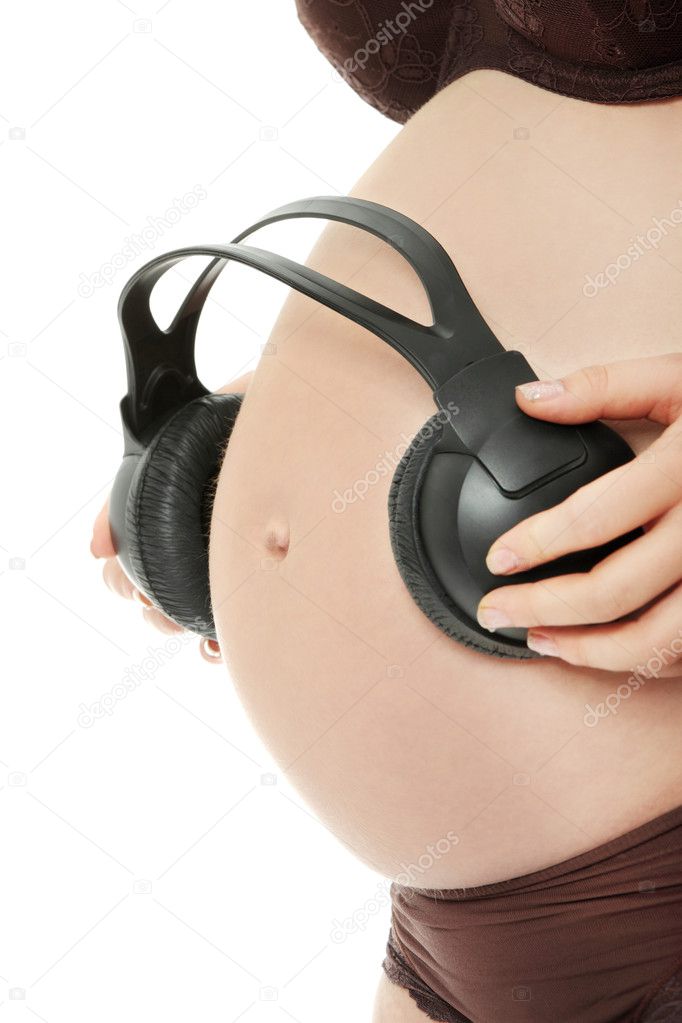 Belly of a pregnant woman with headphones