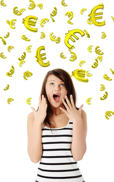 Amazed young caucasian woman looking on falling down euros — Stock Photo, Image