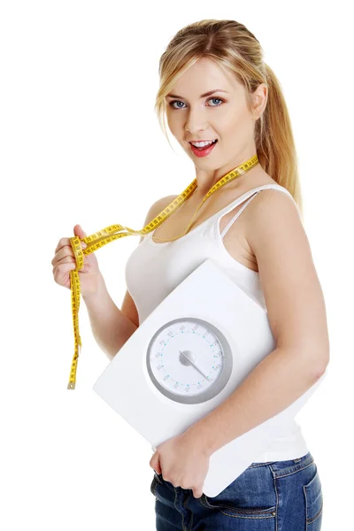 Woman with bathroom scale and measuring tape — Stock Photo, Image