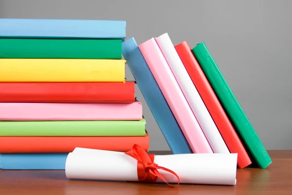 stock image Diploma and stack of books