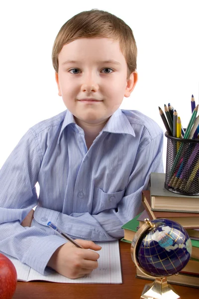 Chłopiec ma zadanie domowe na stole — Zdjęcie stockowe