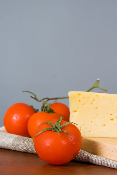 stock image Yellow cheese with tomatoes