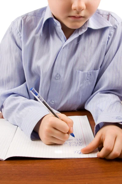 Boy does homework on a table — Stock Photo, Image